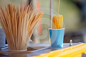 Boiled corn in a glass. Outdoor photo