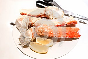Boiled crab phalanges lie on a white plate