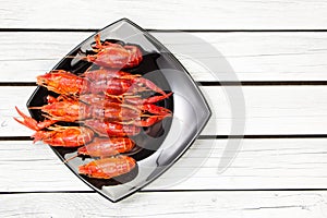 Boiled crawfish. Woden background. Rustic style. Seafood menu.