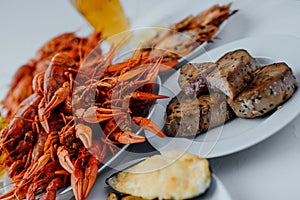 Boiled crayfish, fried tuna steak, fried lobster, mussels and beer