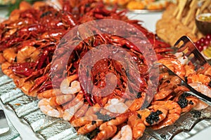 boiled crayfish lie on a platter in a restaurant