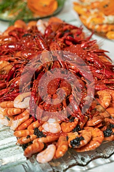 boiled crayfish lie on a platter in a restaurant