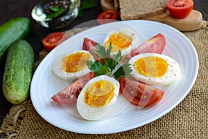 Boiled egg and fresh tomato, black bread - light diet breakfast