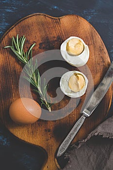 Boiled egg halves on a cutting board.