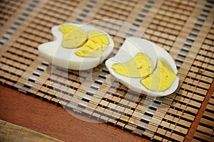 The boiled egg is irregular in shape. Two yolks inside. Cut in half. Organic Hard Boiled Eggs Ready to Eat