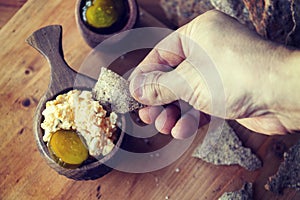 Boiled egg with mayonnaise on thin crispy bread. Traditional Scandinavian breakfast. Hand picks up a piece