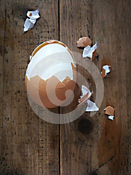 Boiled egg peeled on a wooden background