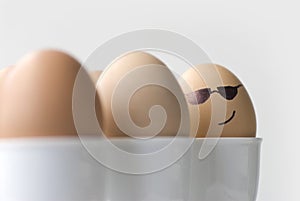 Boiled egg with secret agent spy or mafia smiley face, black sunglasses, mystery suspense concept