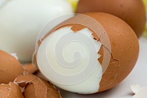 Boiled eggs on plate with broken eggshell