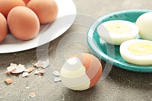 Boiled eggs on plate on grey background