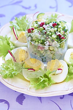 Boiled eggs with salad, cucumber and radish