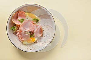Boiled eggs with smoked ham and vegetables. Healthy vegetarian diet. Veggies salad.