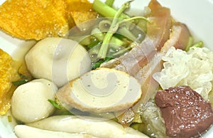 boiled fish ball and line with morning glory vegetable in soup on bowl