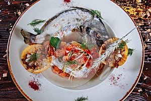 Boiled fish with sauce and fried tomatoes