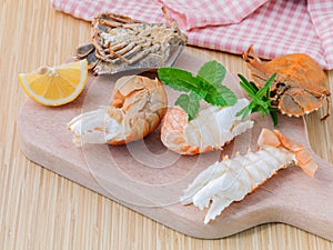 Boiled Flathead lobster, Lobster Moreton Bay bug, Oriental flathead lobster with herbs and spices sauce on wooden background.