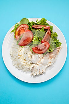 boiled fresh fish with boiled rice and fresh salad