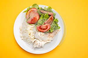 boiled fresh fish with boiled rice and fresh salad