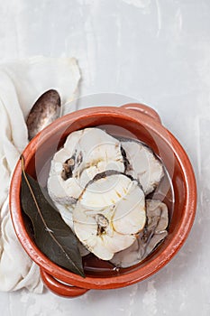 boiled fresh fish in brown ceramic pot