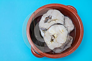 boiled fresh fish in brown ceramic pot