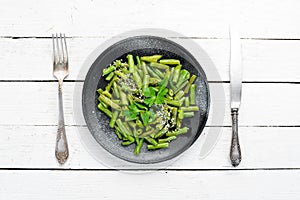 Boiled Green Asparagus Bean. In a black plate. Top view.