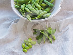 Boiled green soybeans on fabric backgroun