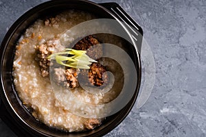 Boiled ground pork and deep fried pork on congee