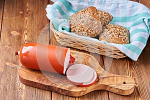 Boiled ham sausage sliced on a wooden kitchen board