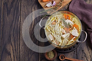 Boiled noodles with chicken in a saucepan with copy space