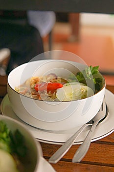 Boiled noodles with chili, cucumber and egg on a plate