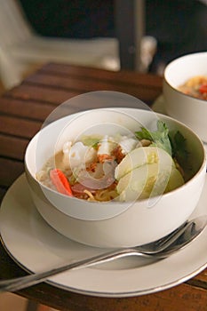 Boiled noodles with chili, cucumber and egg on a plate