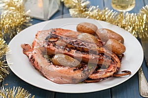 Boiled octopus with potato on white plate