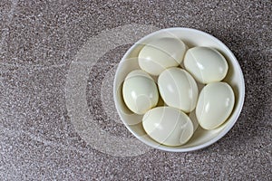 Boiled peeled eggs without shell on a plate. Ingredients for cooking.