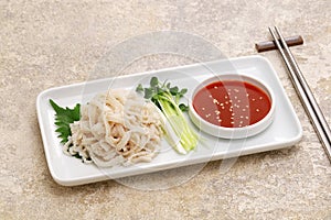 Boiled, peeled and whitened beef omasum sashimi. photo