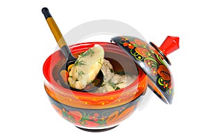 Boiled pelmeni in khokhloma painted russian wooden dish with spoon