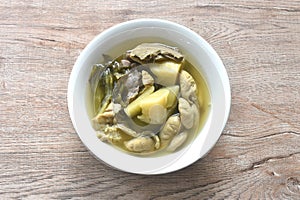 boiled pickled cabbage with pork innard in clear soup on bowl