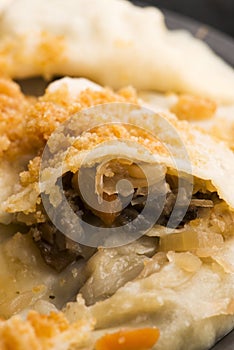 Boiled pierogi Polish dumplings stuffed with cabbage and mushrooms
