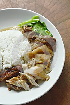 Boiled pork leg in black Chinese herb soup slice with rice on plate