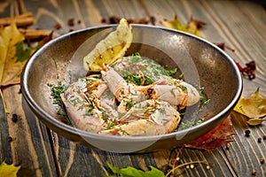 Boiled prawns with lemon and dill are on a plate