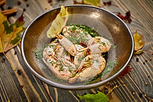 Boiled prawns with lemon and dill are on a plate