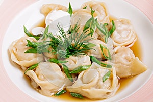 Boiled prepared homemade russian dumplings or pelmeni with beef
