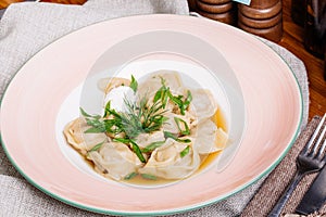 Boiled prepared homemade russian dumplings or pelmeni with beef