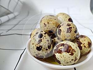 Boiled Quail eggs in the plate on the table.