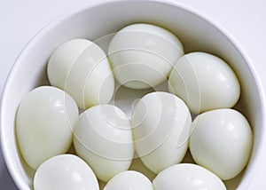 Boiled quail eggs on a white plate  on white background