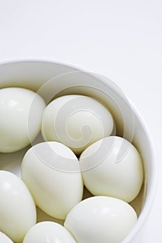 Boiled quail eggs on a white plate  on white background