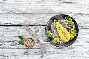 Boiled quinoa with avocado and vegetables.