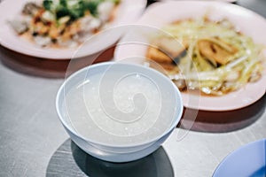 Boiled rice in blue bowl with food for eating which has chopstick.