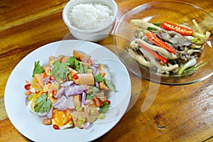 Boiled rice eat with spicy egg salad and stir fried Indian mushroom on table