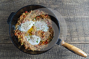 Boiled rice with fried eggs, red peppers, tomato and onions, closeup, Ukraine. Food background. Healthy food