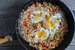 Boiled rice with fried eggs, red peppers, tomato and onions, closeup, Ukraine. Food background. Healthy food