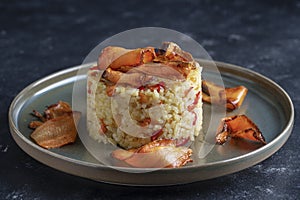 Boiled rice with fried red peppers, carrots and onions, close up